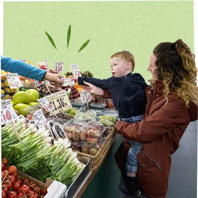 child buying fruit and veg with parent