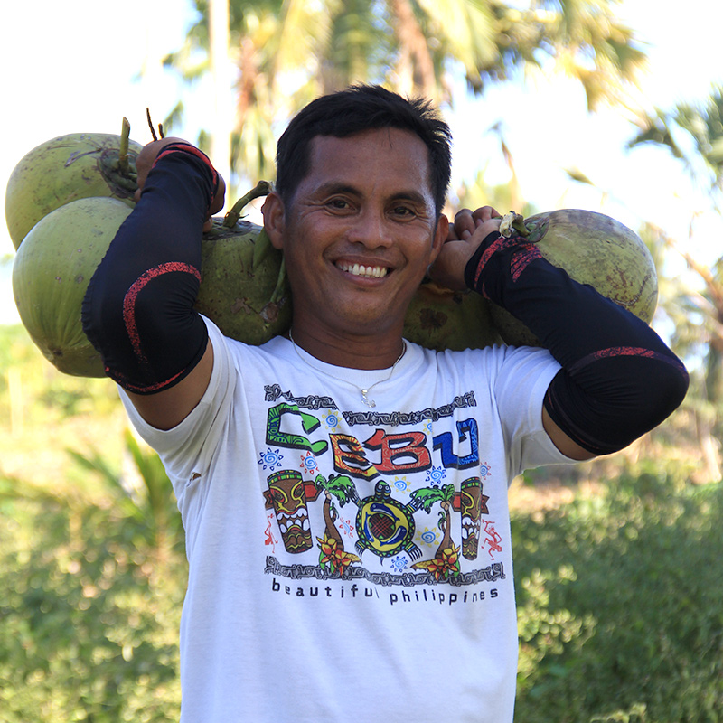 man holding coconuts